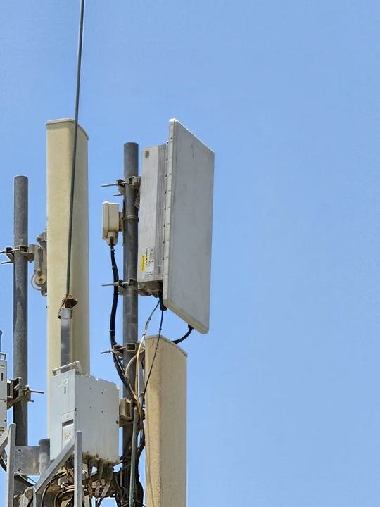 Huawei 5G AAU on a rooftop pole