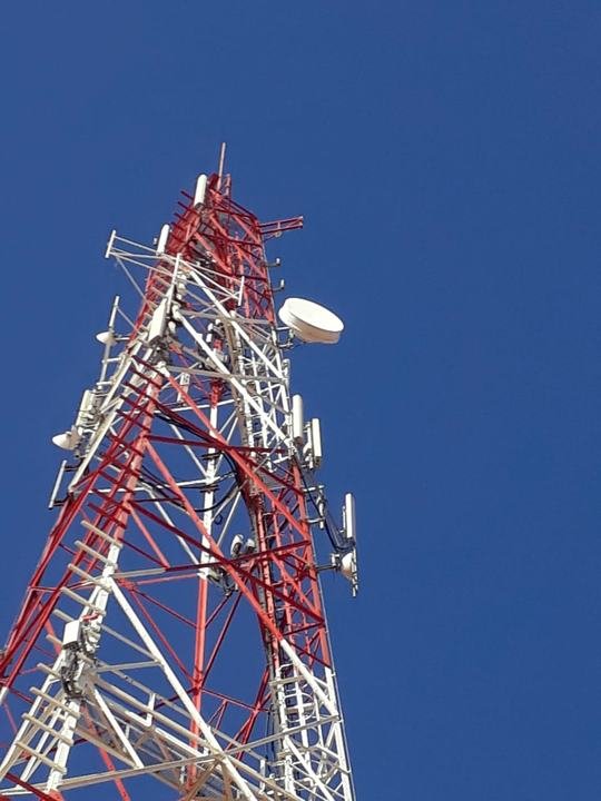 Lattice tower with sector antennas and a microwave dish